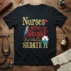 Nurses We Can't Fix Stupid But We Can Sedate It quote on a black t-shirt with medical graphics