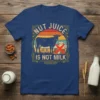 Nut Juice Is Not Milk t-shirt design featuring a cow, vintage sunset, and crossed-out milk pitcher