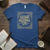 Blue t-shirt featuring the quote "Obstinate, Headstrong Girl Jane Austen" in decorative gold lettering