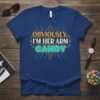Obviously, I'm Her Arm Candy quote on a navy blue t-shirt with retro-style orange and teal typography