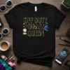 Off Duty Drag Queen text with makeup brushes and feathers graphic on black t-shirt