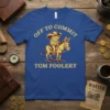 Off To Commit Tom Foolery text with a frog wearing a cowboy hat riding a donkey, on a blue t-shirt