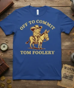 Off To Commit Tom Foolery text with a frog wearing a cowboy hat riding a donkey, on a blue t-shirt