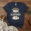 Official Official Sleepshirt t-shirt design featuring two sleeping dogs on clouds, with stars and a moon graphic