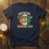 OFFICIAL ST. PATRICK'S DAY DRINKING TEAM text with shamrock and Irish flag colors on a navy t-shirt