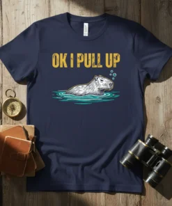 Navy t-shirt with yellow text "OK I PULL UP" above a drawing of a capybara swimming in water with bubbles