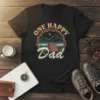 Black t-shirt with "One Happy Dad" text and a circular camping graphic featuring a tent, mountains, and starry night sky