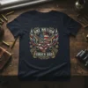 One Nation Under God t-shirt with crossed rifles, American flag, and wings graphic. Patriotic design for American pride