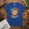 One Smart Cookie text with a cute cartoon cookie wearing glasses on a royal blue t-shirt