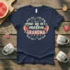 Navy t-shirt with "one in a melon GRANDMA" text surrounded by a floral wreath and watermelon slices graphic