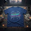 A blue t-shirt with the word "OOPS..." in colorful bubble letters, surrounded by white unicorn outlines