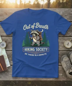 T-shirt with "Out of Breath Hiking Society Be There In A Minute" text and a raccoon hiking graphic