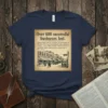 T-shirt design featuring vintage newspaper text "Over 600 successful businesses lost." with a historical town illustration