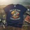 Navy blue t-shirt with vintage sunset graphic, featuring a jumping bass and the text "Papa Is My Name Fishing Is