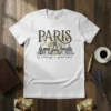 White t-shirt with black and gold "Paris is always a good idea" text and illustration of Parisian landmarks