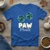 Blue t-shirt with "PAW Prints" text and two green paw print graphics, designed for dog lovers