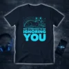 Cyan text "Pay Attention To Me Ignoring You" above a stylized cat illustration on a dark navy t-shirt