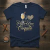 Peace Love Coquito text with a glass of coquito, peace sign, and heart graphic on a navy t-shirt