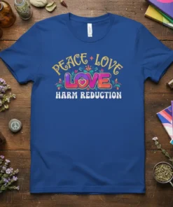 Peace Love Harm Reduction text design with heart and floral accents on a blue t-shirt