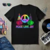 Black t-shirt with colorful "Peace Love Joy" text, two geometric gnomes, and a neon peace sign graphic