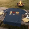 Peace Love S'mores graphic t-shirt with icons for peace, heart, and s'more, set against a campfire background