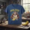 T-shirt with "Peel This!" text above a muscular cartoon monkey holding a banana