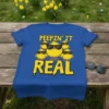 Peepin' It Real text with a group of cool cartoon chicks wearing sunglasses on a royal blue t-shirt