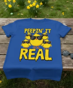 Peepin' It Real text with a group of cool cartoon chicks wearing sunglasses on a royal blue t-shirt