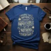 Blue t-shirt with the quote "People Say Nothing Is Impossible But I Do Nothing Everyday" in vintage gold typography, featuring