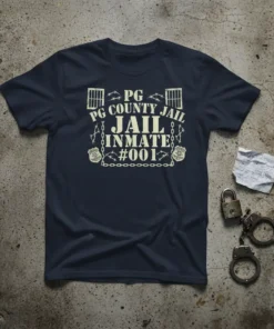 Navy t-shirt with "PG COUNTY JAIL INMATE #001" text, prison bars, and handcuffs graphic