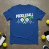 Pickleball Life heartbeat t-shirt design featuring white text and graphics of crossed paddles and a ball, symbolizing a love for
