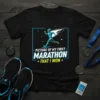 Black t-shirt featuring a blue and white graphic of a runner in motion, with text "Picture of My First Marathon