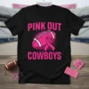 Black t-shirt with pink text "PINK OUT COWBOYS" and a pink football with a pink ribbon