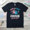 Pink or Blue Cousin Loves You text with baby footprints design on a dark t-shirt, gender reveal theme