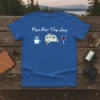 Blue t-shirt with "Plan For The Day" text, coffee cup, camper, and wine glass graphic