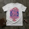 White t-shirt with pink and blue text reading "Playing Dress to Impress With My Baddies" and featuring a pink cowboy