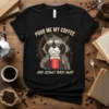 Black t-shirt featuring a grumpy raccoon holding a coffee mug with the text "Pour Me My Coffee And Slowly Back