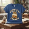 Powered By Cookies text with a cookie jar graphic on a blue t-shirt, suitable for bakers and cookie lovers
