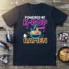 Graphic t-shirt design with neon text "POWERED BY K-POP & RAMEN" and a bowl of ramen illustration