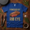 Royal blue t-shirt with gold text "POWERED BY RIB EYE" and a realistic image of a grilled rib eye steak
