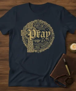 Navy blue t-shirt with gold text "Pray On It. Pray Over It. Pray Through It." around a Celtic cross design