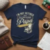 Navy t-shirt with text "I'm Not Retired I'm A Professional Papa" and an illustration of a rocking chair with books