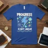 Blue t-shirt with the quote "PROGRESS IS NOT LINEAR" in white and yellow, surrounded by colorful graphics of a lightning