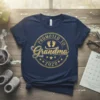 Promoted to Grandma 2020 text with baby footprints graphic on a navy t-shirt