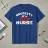 Property Of A Hot Nurse text design on a blue t-shirt, featuring distressed white lettering and a red "HOT" accent