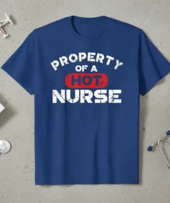 Property Of A Hot Nurse text design on a blue t-shirt, featuring distressed white lettering and a red "HOT" accent
