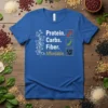 Protein. Carbs. Fiber. Affordable. text with icons of flowers, peas, and beans on a blue t-shirt