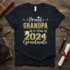 Proud Grandpa of a Class of 2024 Graduate text with graduation cap graphic on a black t-shirt