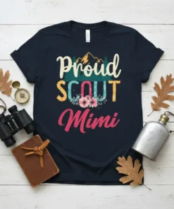 Proud SCOUT Mimi t-shirt design with mountains, trees, and floral accents. Features the text "Proud SCOUT Mimi" in colorful lettering