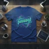 Neon "psssst!" text design on a blue t-shirt, featuring geometric shapes and subtle graphic elements